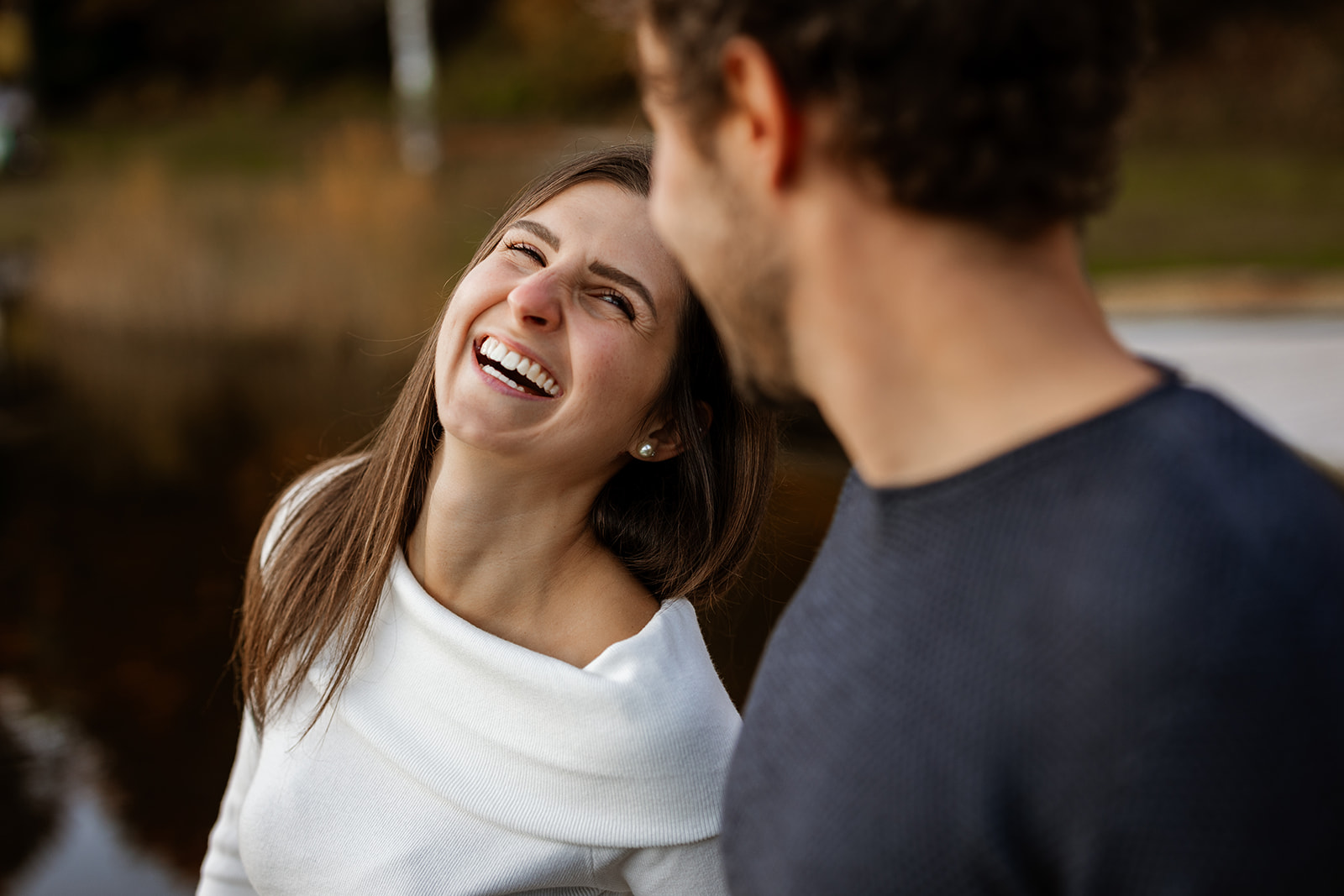 Couple laughing together during a natural engagement photography session in Italy