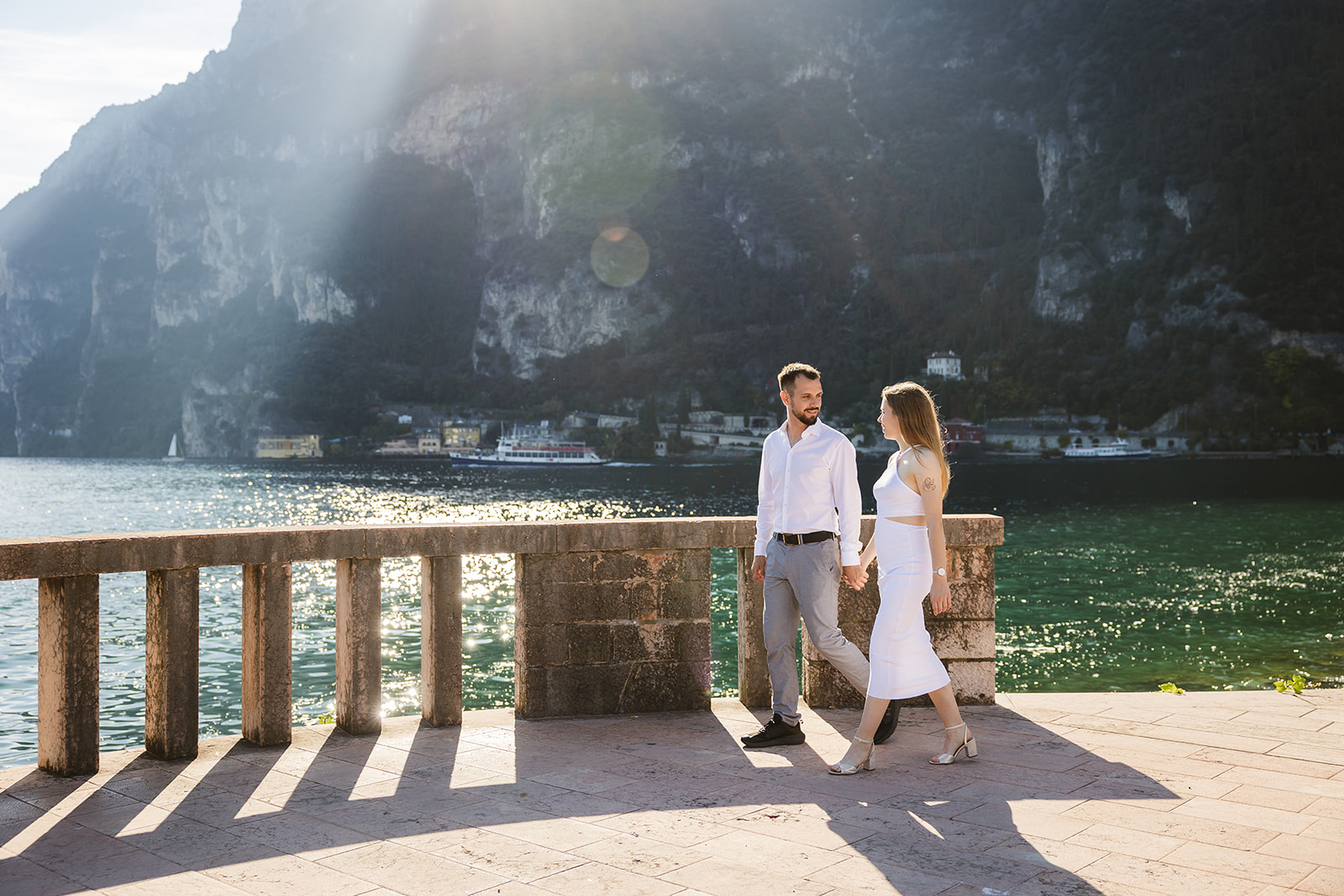Lake Garda engagement photos in Riva del Garda during golden hour on the waterfront promenade