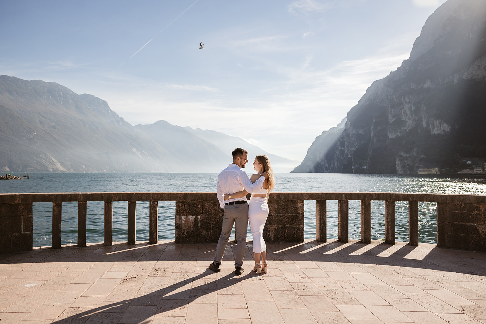 Engagement photos in Riva del Garda with Lake Garda and mountain backdrop at sunset