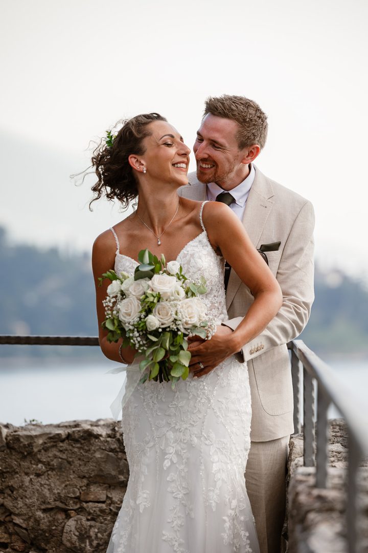Wedding couple laughing together at Castello di Malcesine on Lake Garda, destination wedding photography Italy
