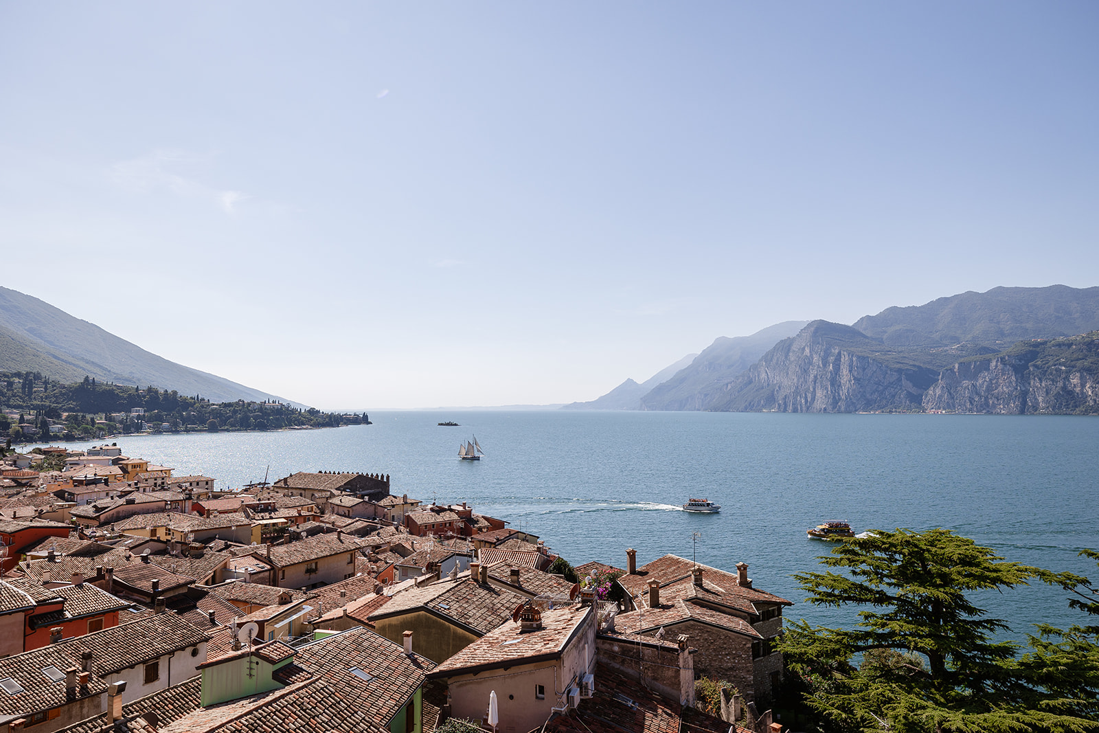 Panoramic view from Castello di Malcesine overlooking Lake Garda during a wedding ceremony setup