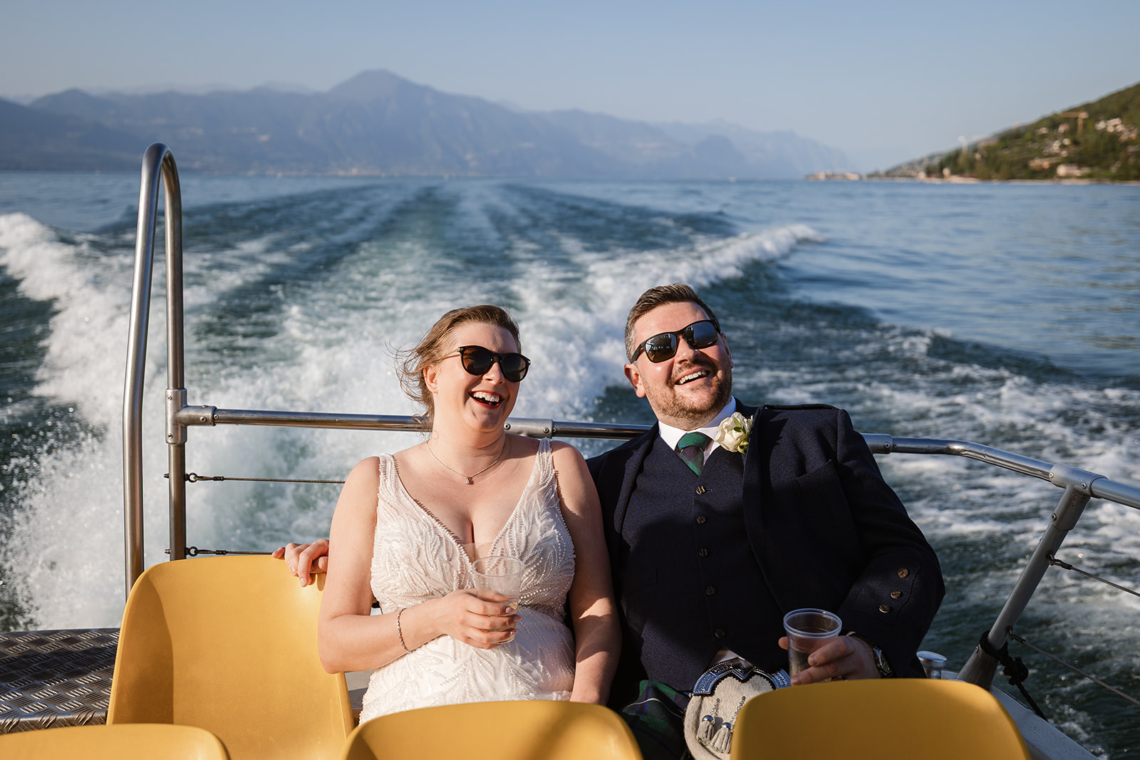 Lake Garda wedding boat transfer with bride and groom enjoying a private boat ride after their ceremony at Castello di Malcesine