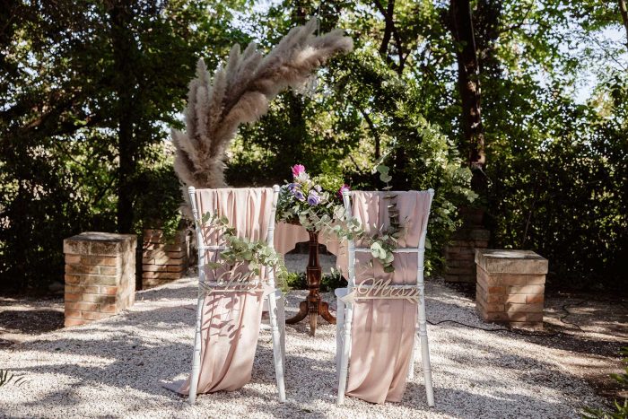 Romantic outdoor wedding ceremony setup on Lake Garda during wedding season in Italy with decorated chairs and floral arrangements