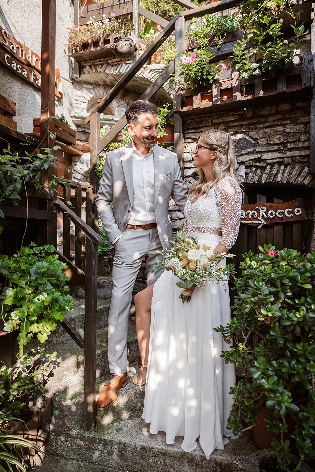 Bride and groom portrait in a hidden corner of Limone sul Garda village during their Lake Garda wedding