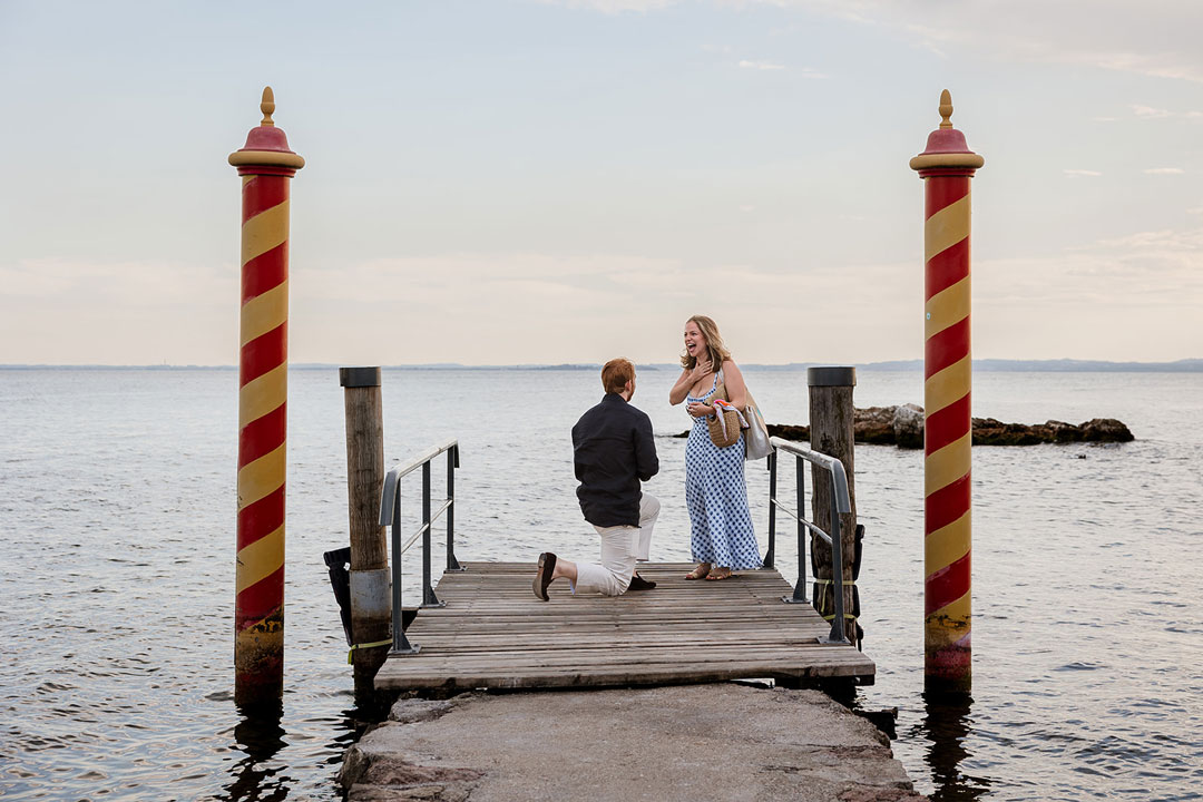 Girl surprised for proposal at Punta san Vigilio, lake Garda