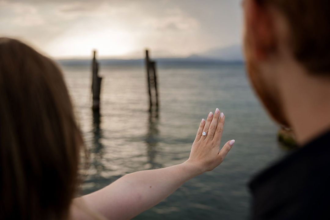 Woman showing her engagement ring after a proposal at Punta San Vigilio on Lake Garda
