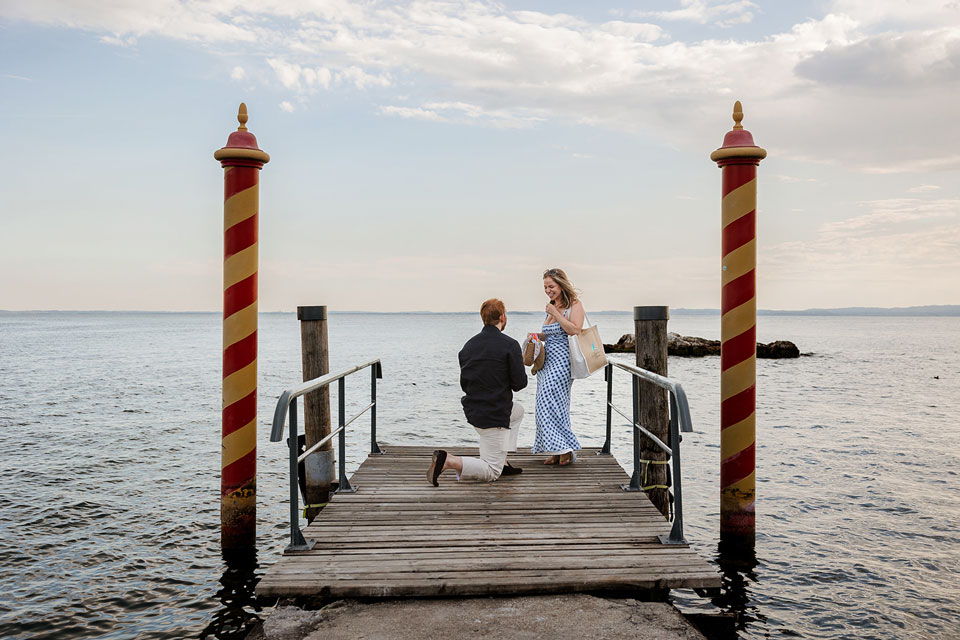 Man proposing to his partner at Punta San Vigilio on Lake Garda